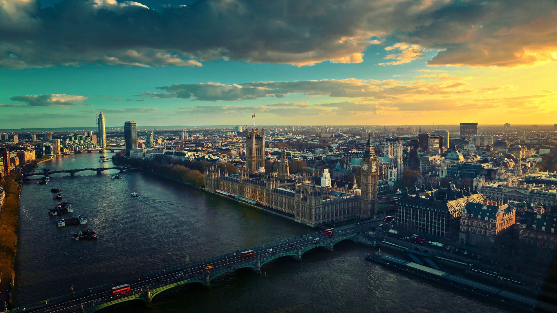 Birds-eye view of the City of London. The River Thames can be seen in the foreground, with other London famous buildings including the Tower of London and Houses of Parliament in the background.